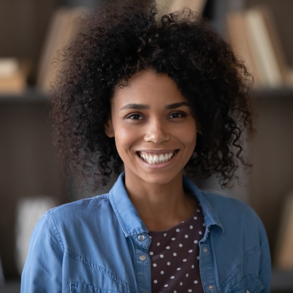 Head shot portrait of happy millennial confident African American businesswoman worker employee looking at camera, profile photo for professional social network, corporate career, female leadership.