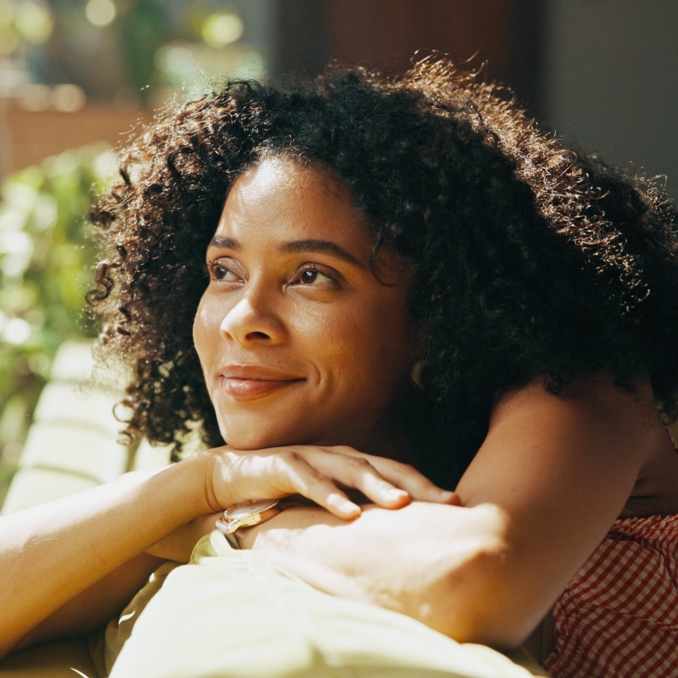 Thinking, daydreaming and woman relaxing in home on weekend with memory, self reflection or gratitude. Happy, calm and female person with decision, choice or peaceful morning on sofa in apartment.