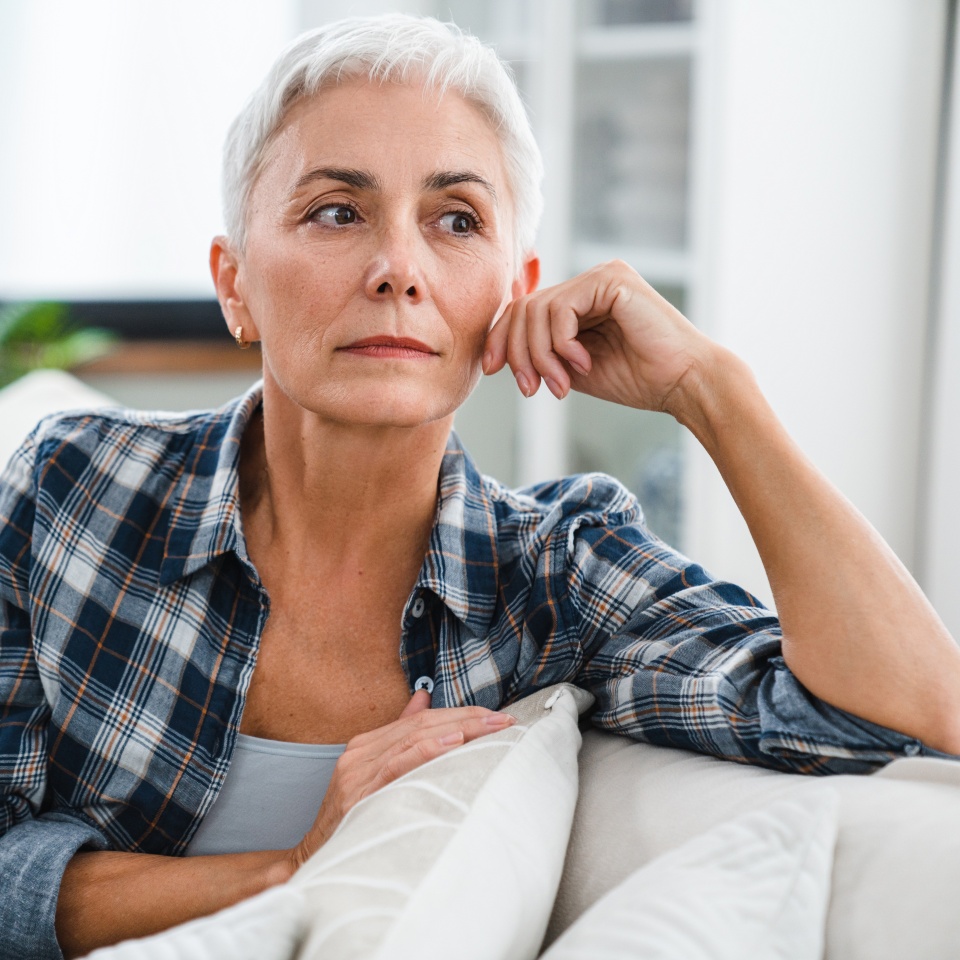 Depression and sadness concept. Caucasian middle-aged woman suffering from health issues at home. Mature housewife thinking having negative feelings, nostalgy